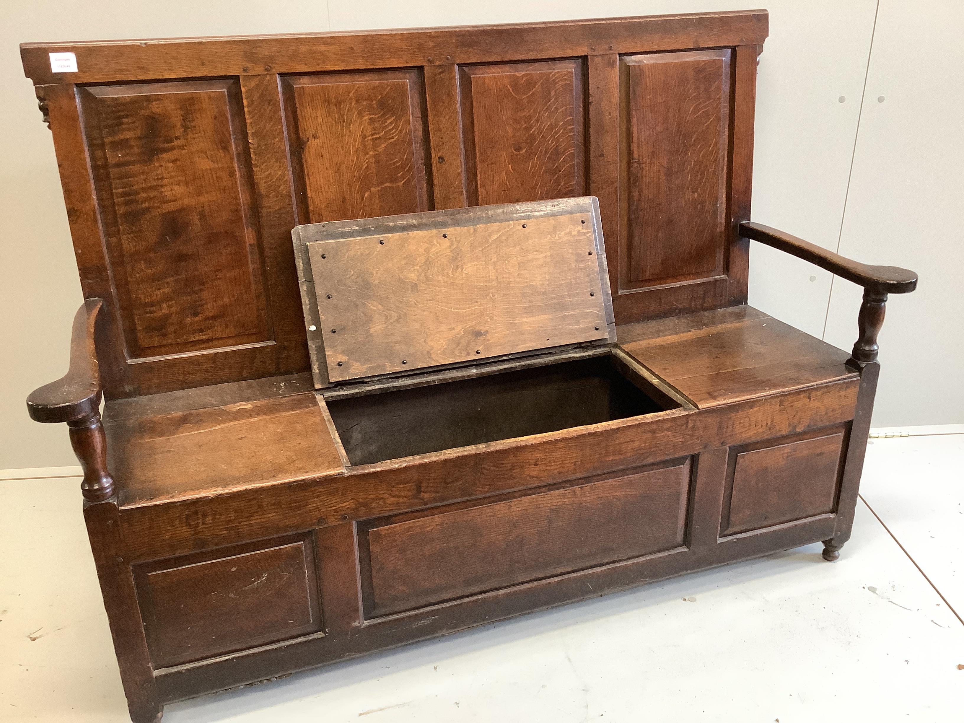 An 18th century panelled oak box seat settle, width 153cm, depth 51cm, height 108cm